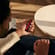 Man holding a Ploom device with Lava Red Front Panel