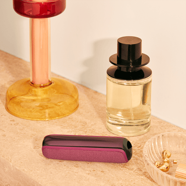 Masanın üzərində dayanan Ploom AURA Dark Orchid cihazı